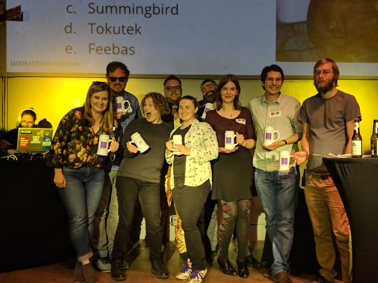 Our 1st Place team, U+1F984, on-stage with our emcee, CooperQ.